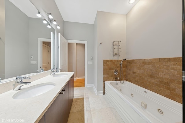 bathroom with tile patterned flooring, vanity, and a bathing tub