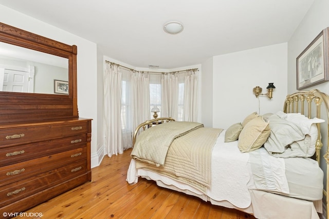 bedroom with hardwood / wood-style flooring