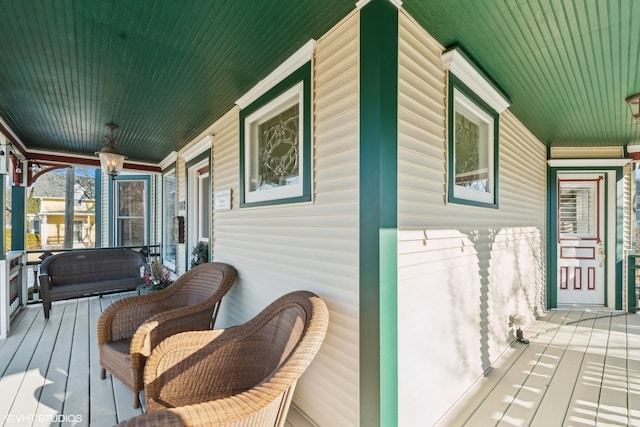 wooden terrace featuring covered porch