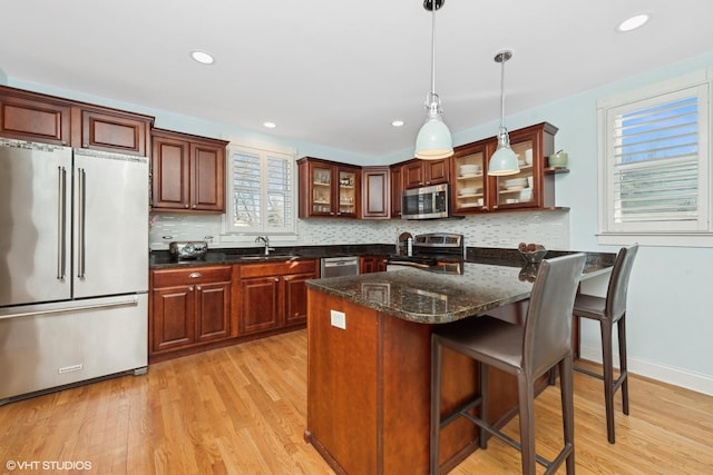 kitchen with sink, decorative light fixtures, plenty of natural light, and appliances with stainless steel finishes