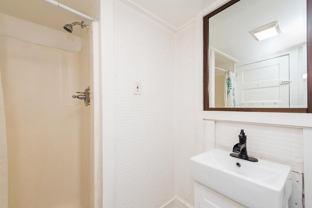 bathroom with walk in shower and sink