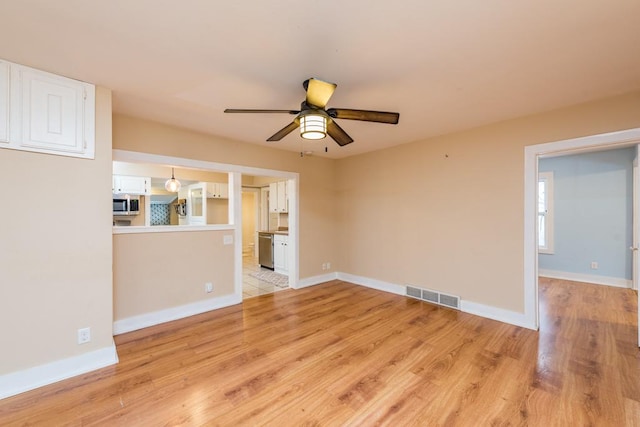 unfurnished living room featuring ceiling fan and light hardwood / wood-style flooring