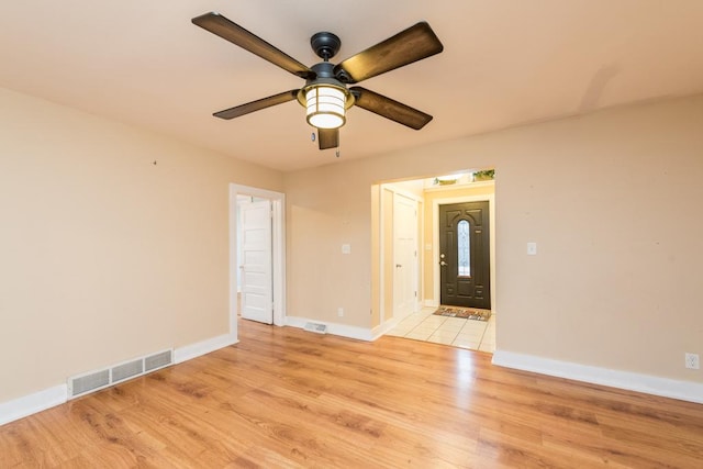 empty room featuring ceiling fan and light wood-type flooring