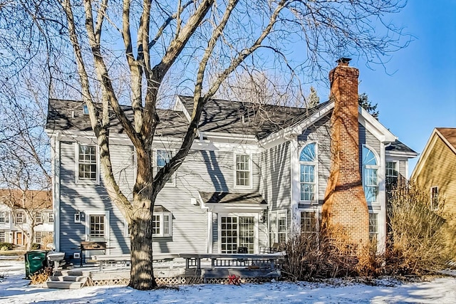 snow covered property featuring a deck