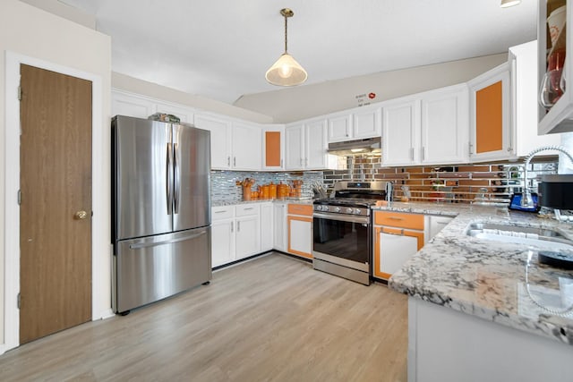 kitchen with sink, decorative light fixtures, white cabinetry, light stone countertops, and appliances with stainless steel finishes