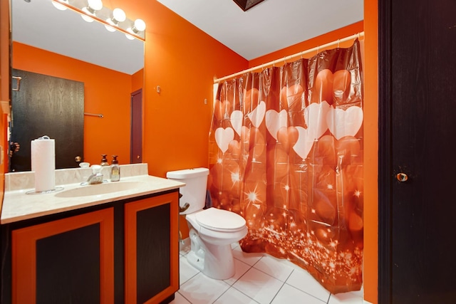 bathroom featuring vanity, tile patterned flooring, and toilet