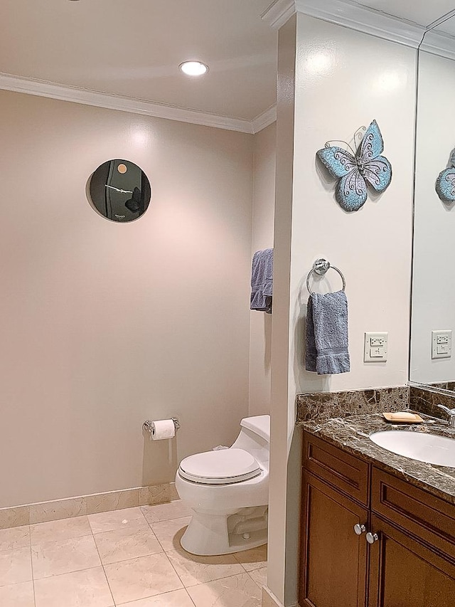 bathroom featuring toilet, vanity, tile patterned floors, and ornamental molding