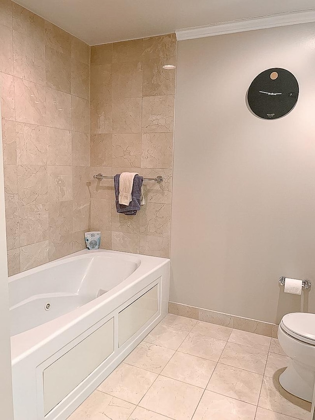 bathroom featuring tile patterned flooring, a tub, crown molding, and toilet