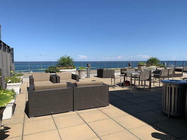 view of patio with a water view and an outdoor living space