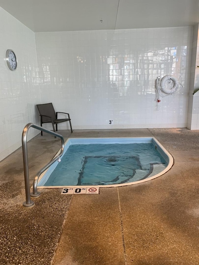 view of swimming pool featuring an indoor in ground hot tub