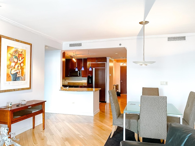 dining room with ceiling fan, light hardwood / wood-style floors, and crown molding