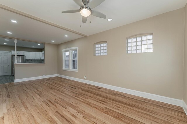 unfurnished room with ceiling fan and light hardwood / wood-style flooring