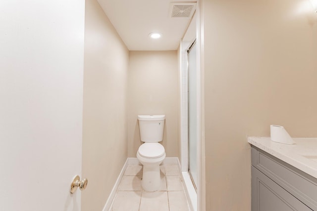 bathroom with toilet, vanity, tile patterned floors, and a shower with shower door