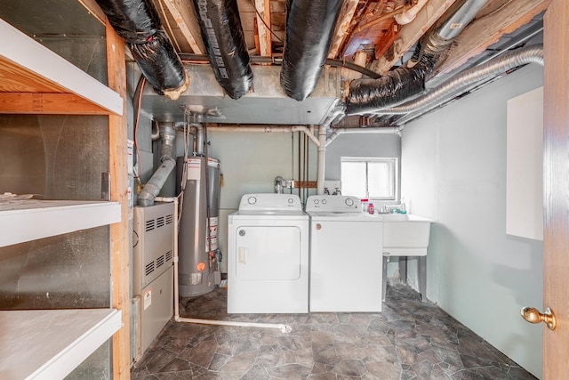 clothes washing area featuring independent washer and dryer and gas water heater