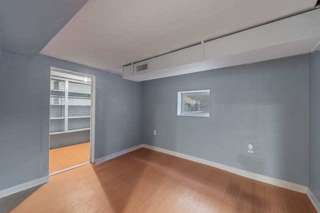 basement with hardwood / wood-style floors