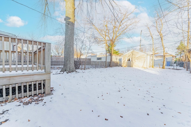 yard covered in snow featuring a wooden deck