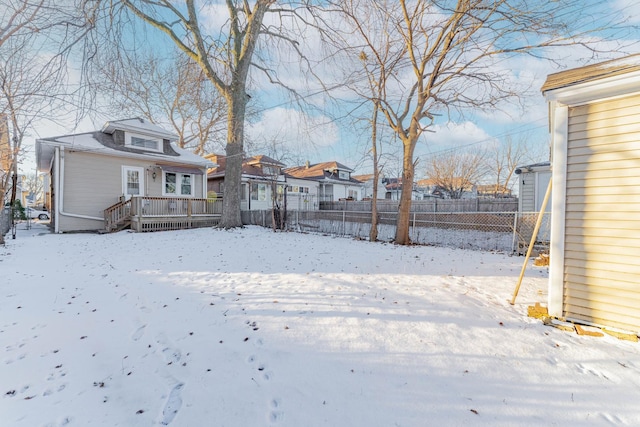 yard covered in snow featuring a wooden deck