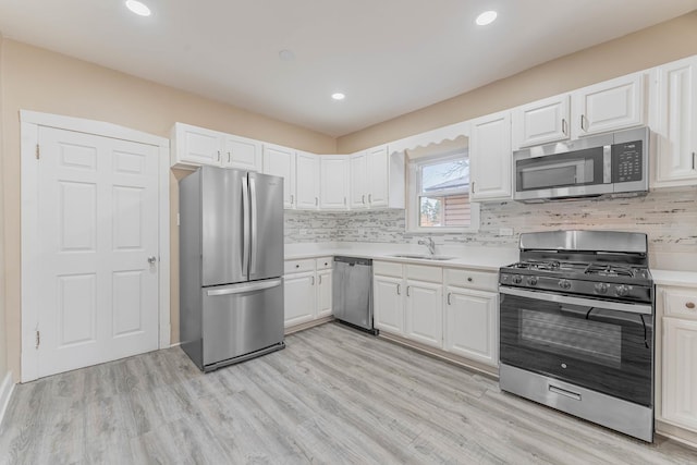 kitchen with stainless steel appliances and white cabinetry