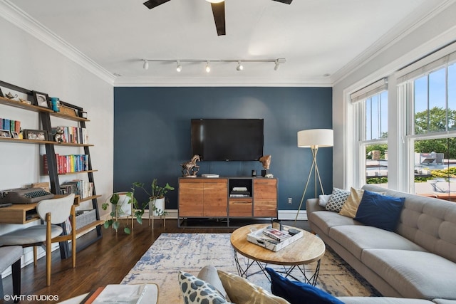 living room with dark wood-type flooring, track lighting, ceiling fan, and ornamental molding