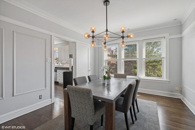 dining space with dark hardwood / wood-style flooring, crown molding, and a chandelier