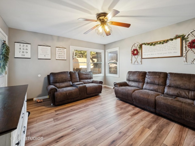 living room featuring ceiling fan and light wood-type flooring