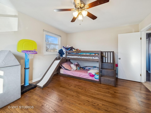 bedroom featuring ceiling fan and dark wood-type flooring