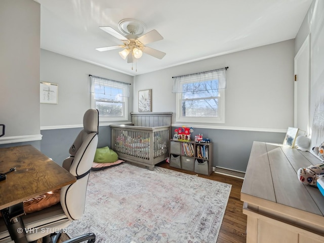 office space with ceiling fan and dark hardwood / wood-style flooring