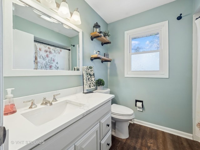 bathroom with vanity, toilet, and hardwood / wood-style floors