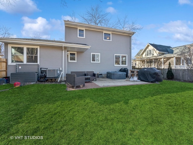 back of house featuring a patio area and a lawn