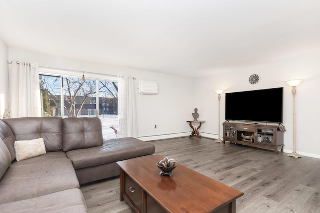 living room with a baseboard radiator and light hardwood / wood-style flooring