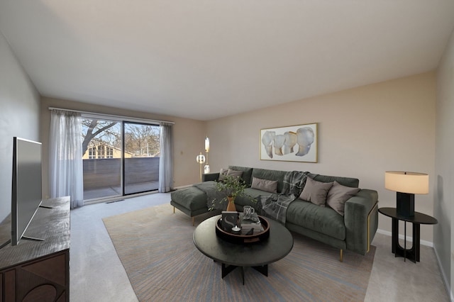 carpeted living area with visible vents and baseboards