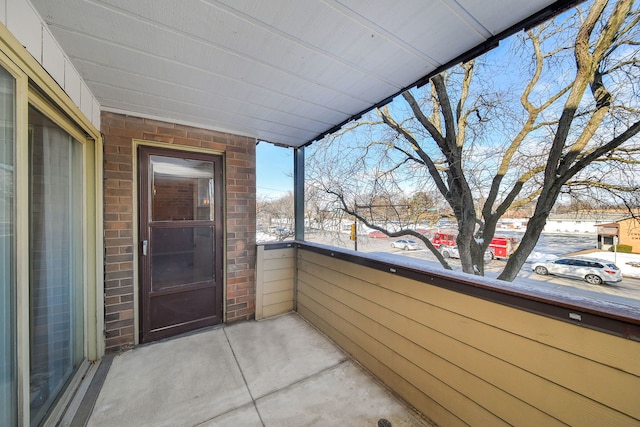 view of snow covered back of property