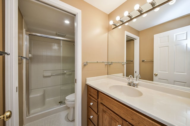 full bathroom featuring vanity, visible vents, tile patterned floors, toilet, and a shower with door