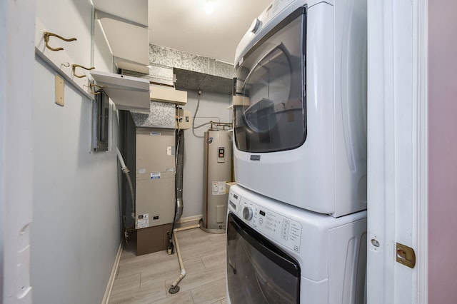 washroom with stacked washer and clothes dryer, heating unit, water heater, light wood-style floors, and laundry area