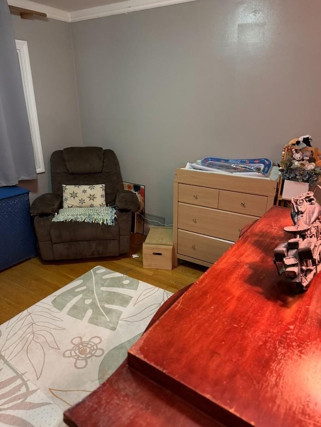 bedroom featuring light hardwood / wood-style floors and ornamental molding