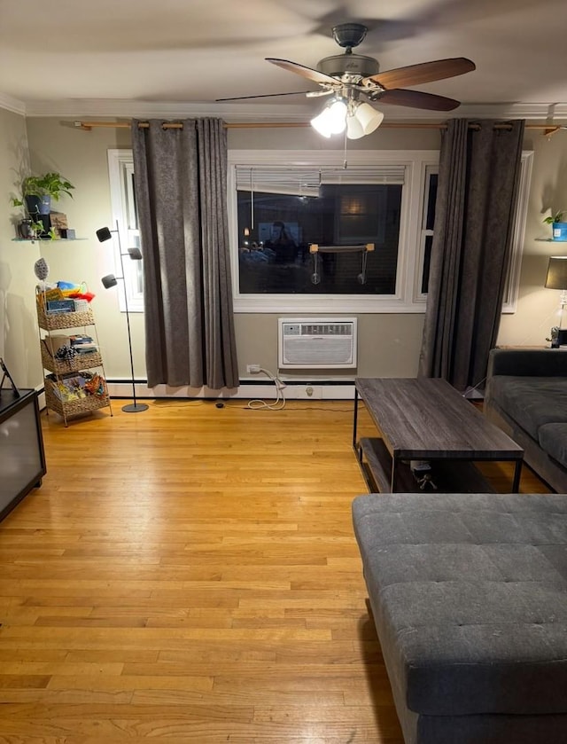 living room featuring an AC wall unit, light wood-type flooring, ceiling fan, and ornamental molding