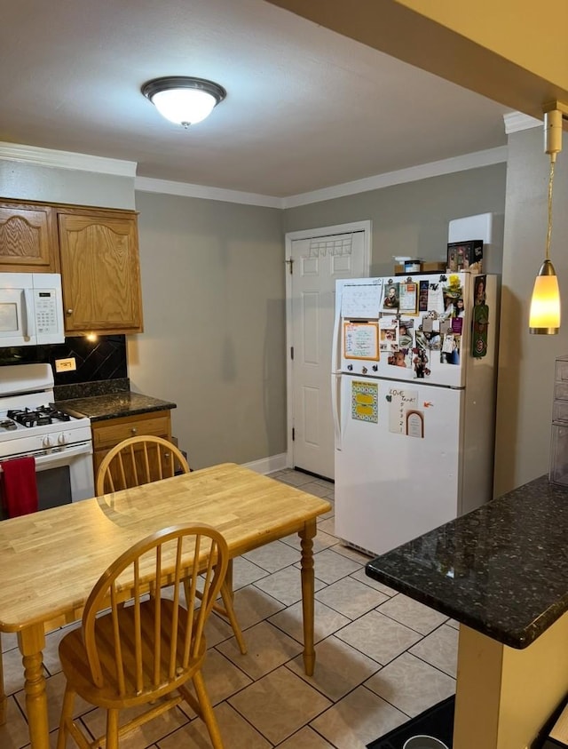 kitchen featuring white appliances, crown molding, and tasteful backsplash