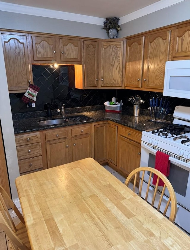 kitchen featuring white appliances, light tile patterned floors, tasteful backsplash, dark stone countertops, and sink