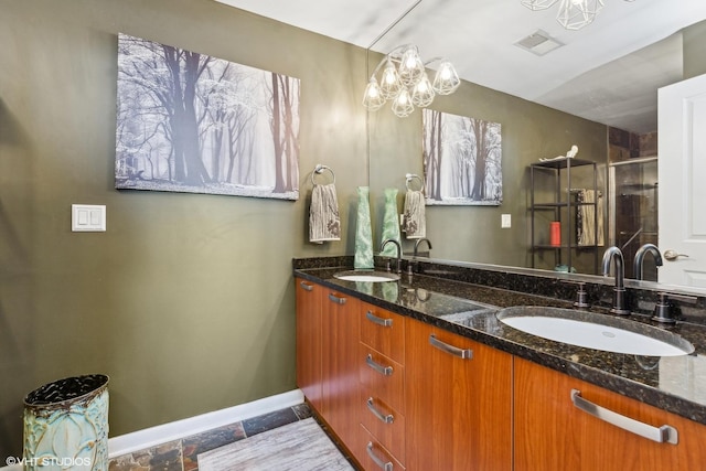 bathroom with vanity and a notable chandelier