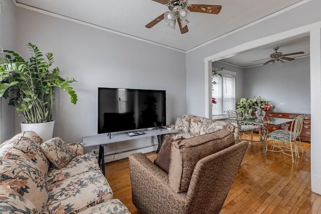 living room featuring a baseboard heating unit, light wood-type flooring, ceiling fan, and crown molding