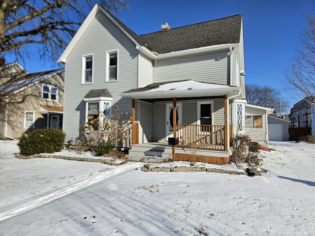 view of property with covered porch and a garage