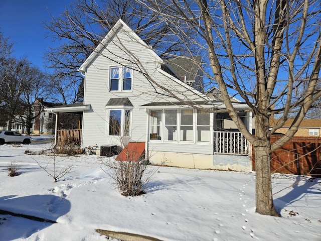 view of front facade with covered porch and central AC