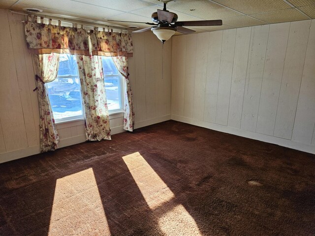 spare room with wood-type flooring and wooden walls