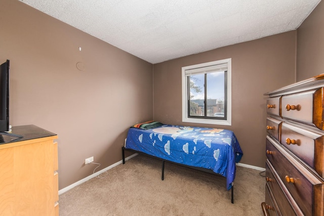 carpeted bedroom featuring a textured ceiling