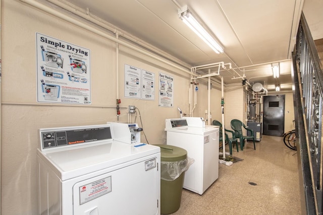 clothes washing area with separate washer and dryer