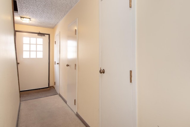 hallway with a textured ceiling