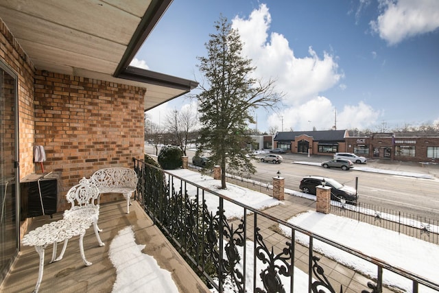 view of snow covered back of property