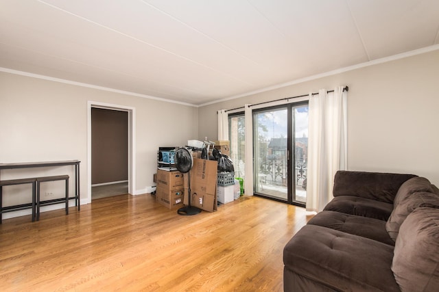 living room with hardwood / wood-style flooring and crown molding