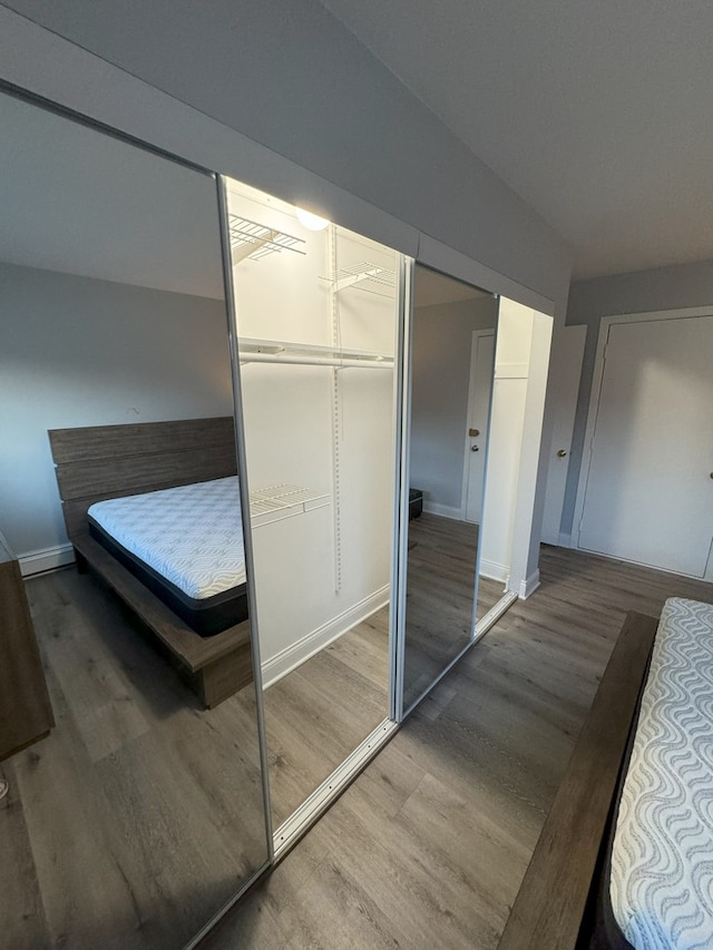 bedroom with wood finished floors and baseboards