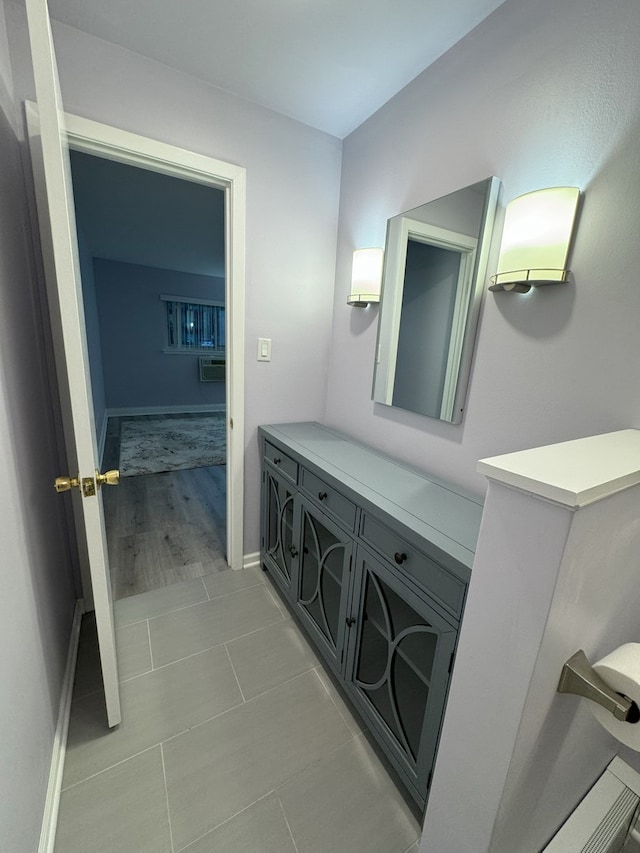 bathroom with tile patterned floors, baseboards, and vanity